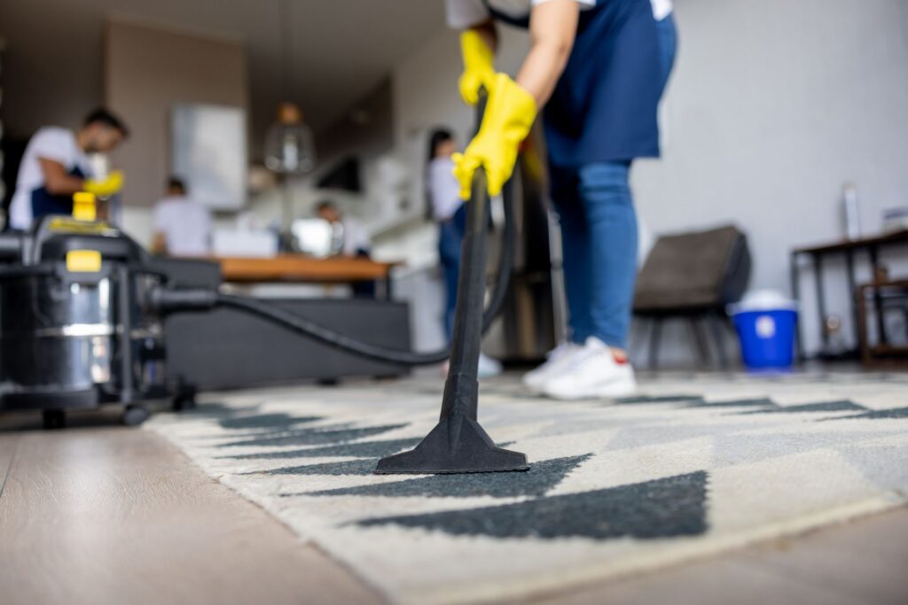Detailed sanitization of kitchen surfaces and cabinet exteriors for a deep clean service.